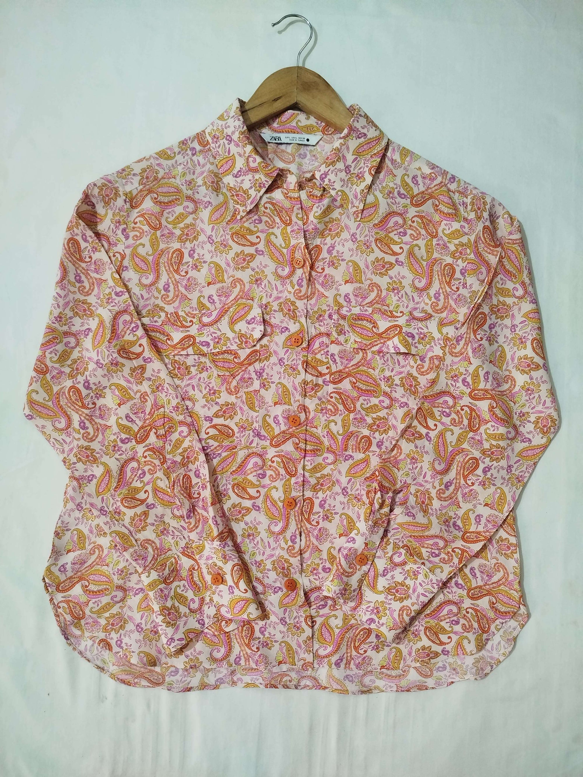 Pink patterned shirt on a white background
