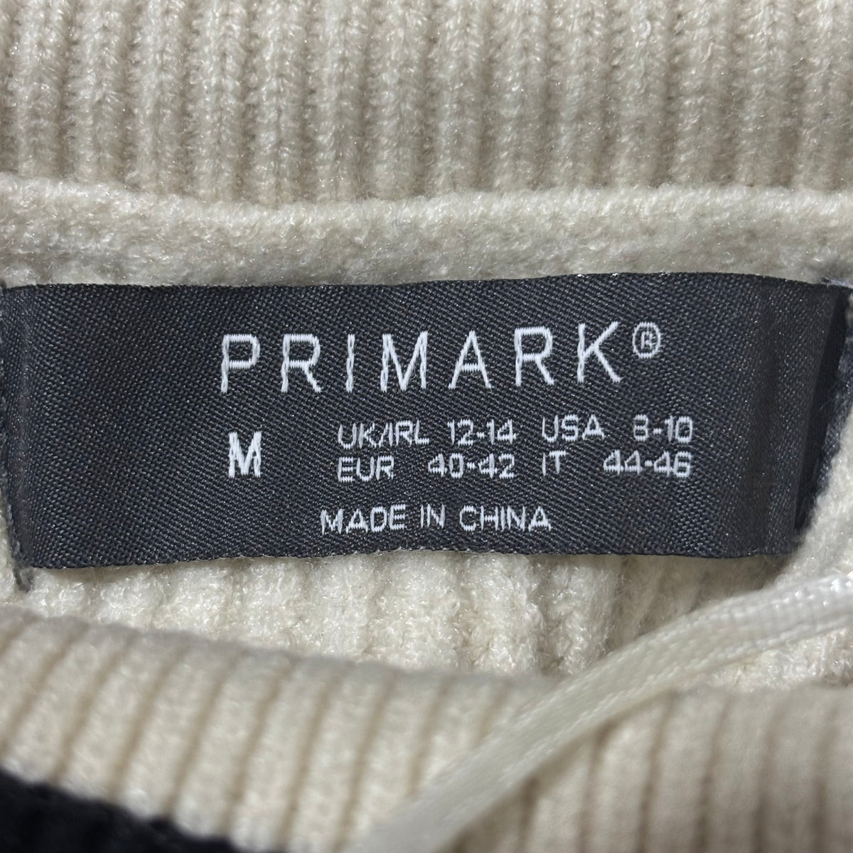 Primark cream and black sweater size M label