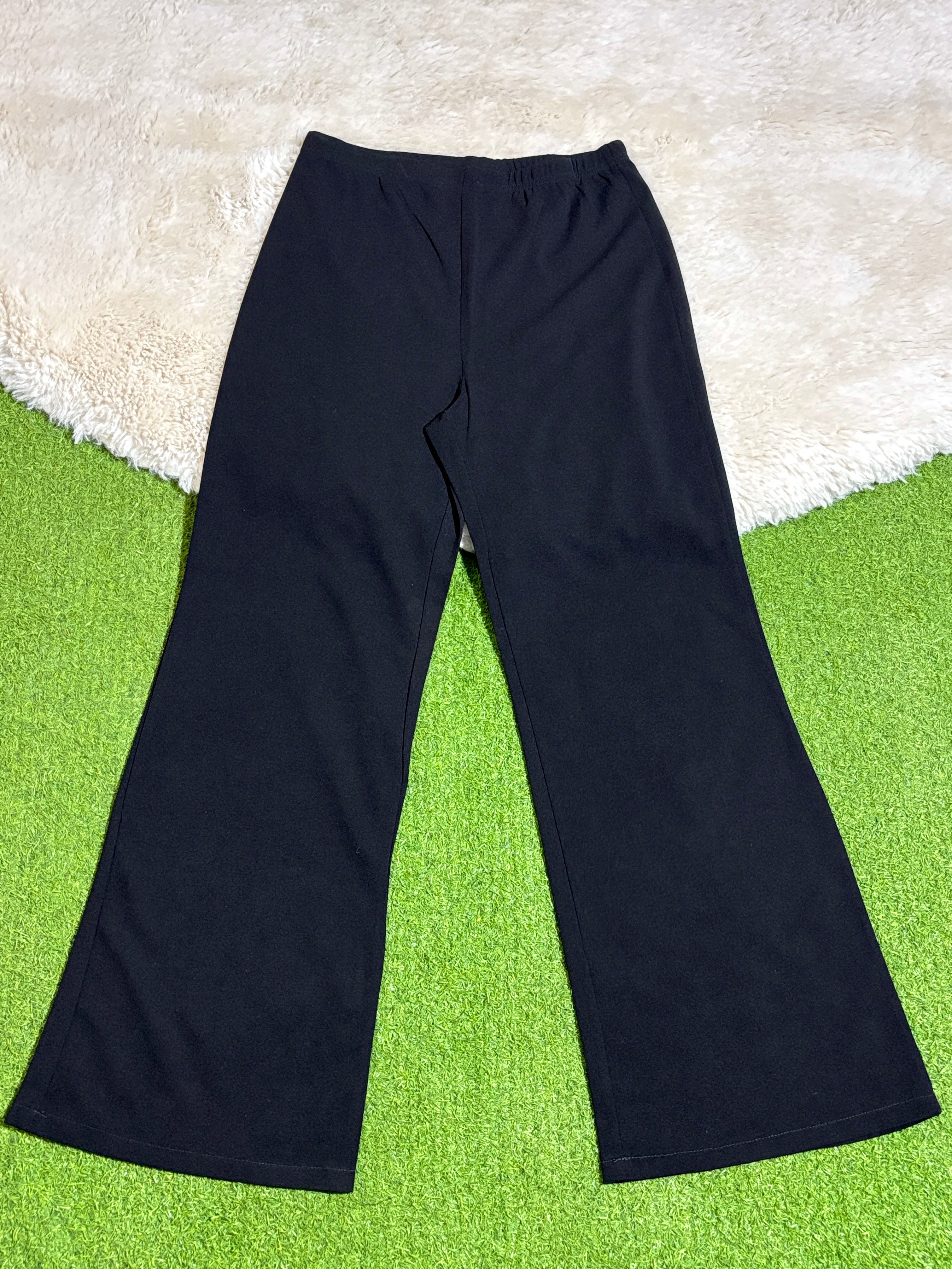 Black high-rise flared trousers laid flat