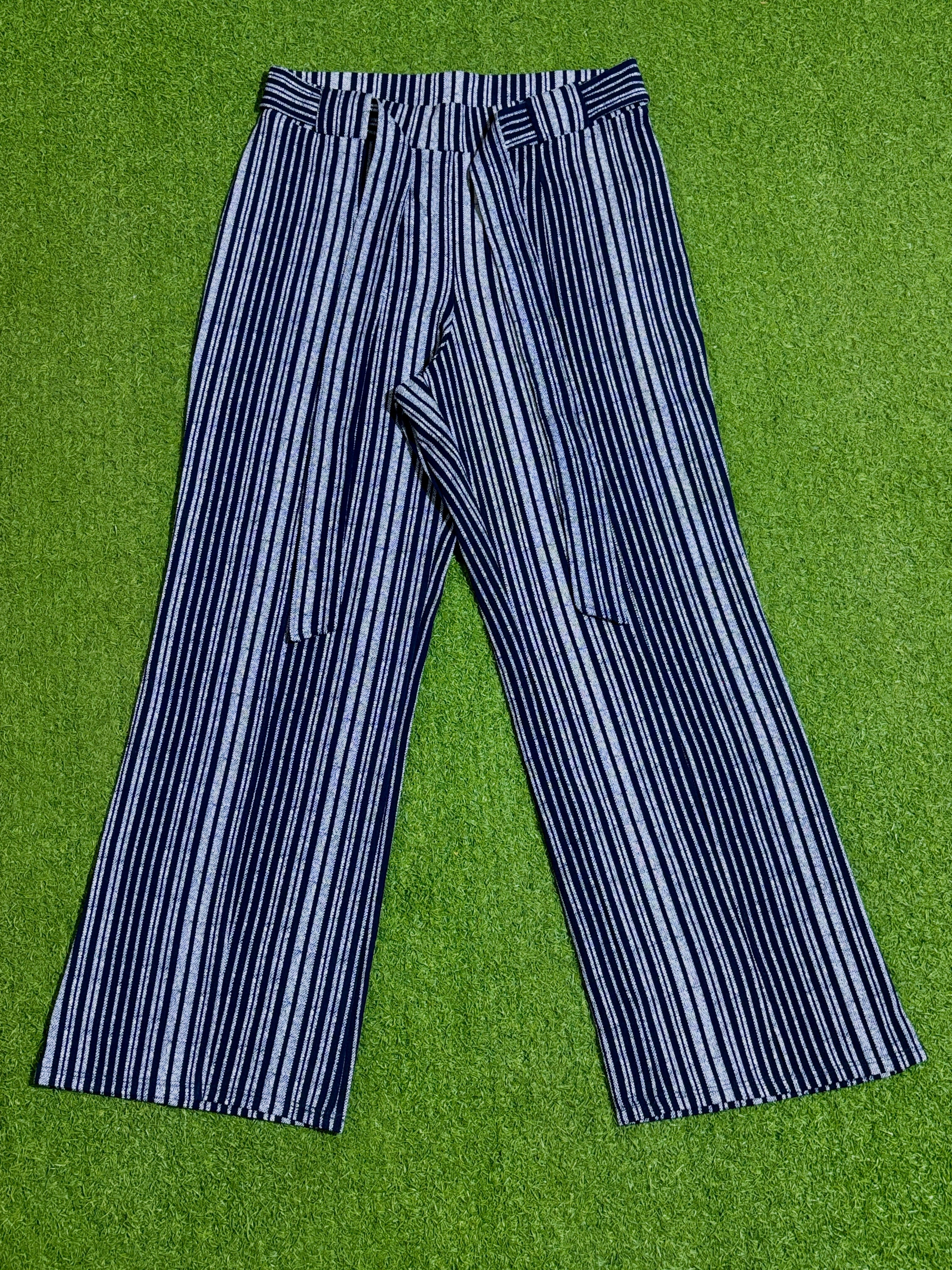 Black and white vertical striped wide-leg trousers laid flat