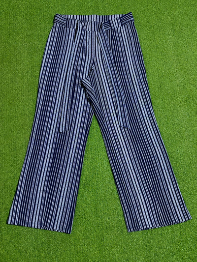 Black and white vertical striped wide-leg trousers laid flat