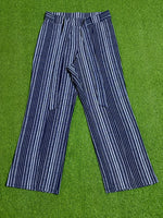 Black and white vertical striped wide-leg trousers laid flat
