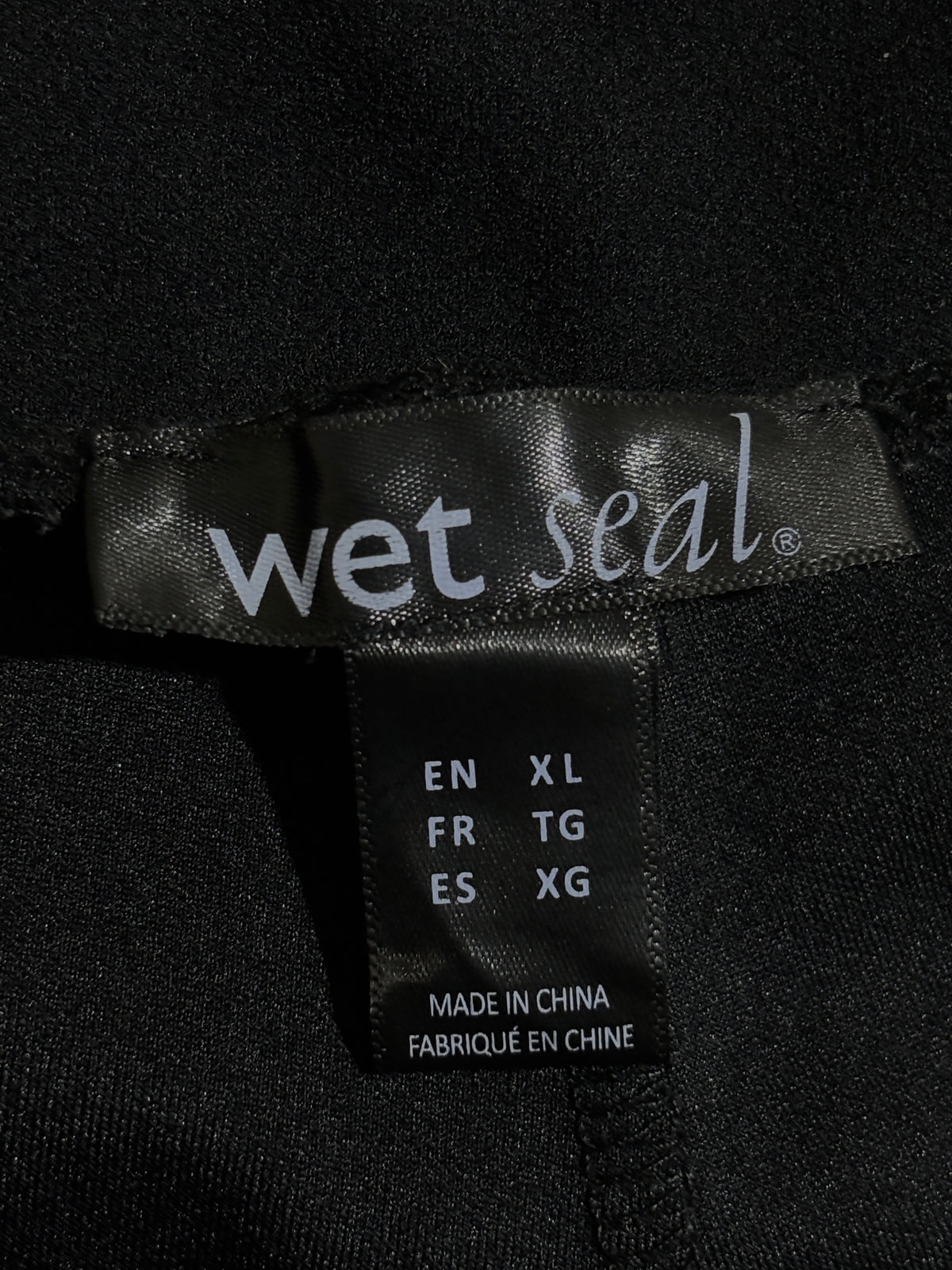 Wet Seal size XL label inside black trousers