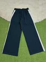 Navy blue trousers with white side stripes laid flat