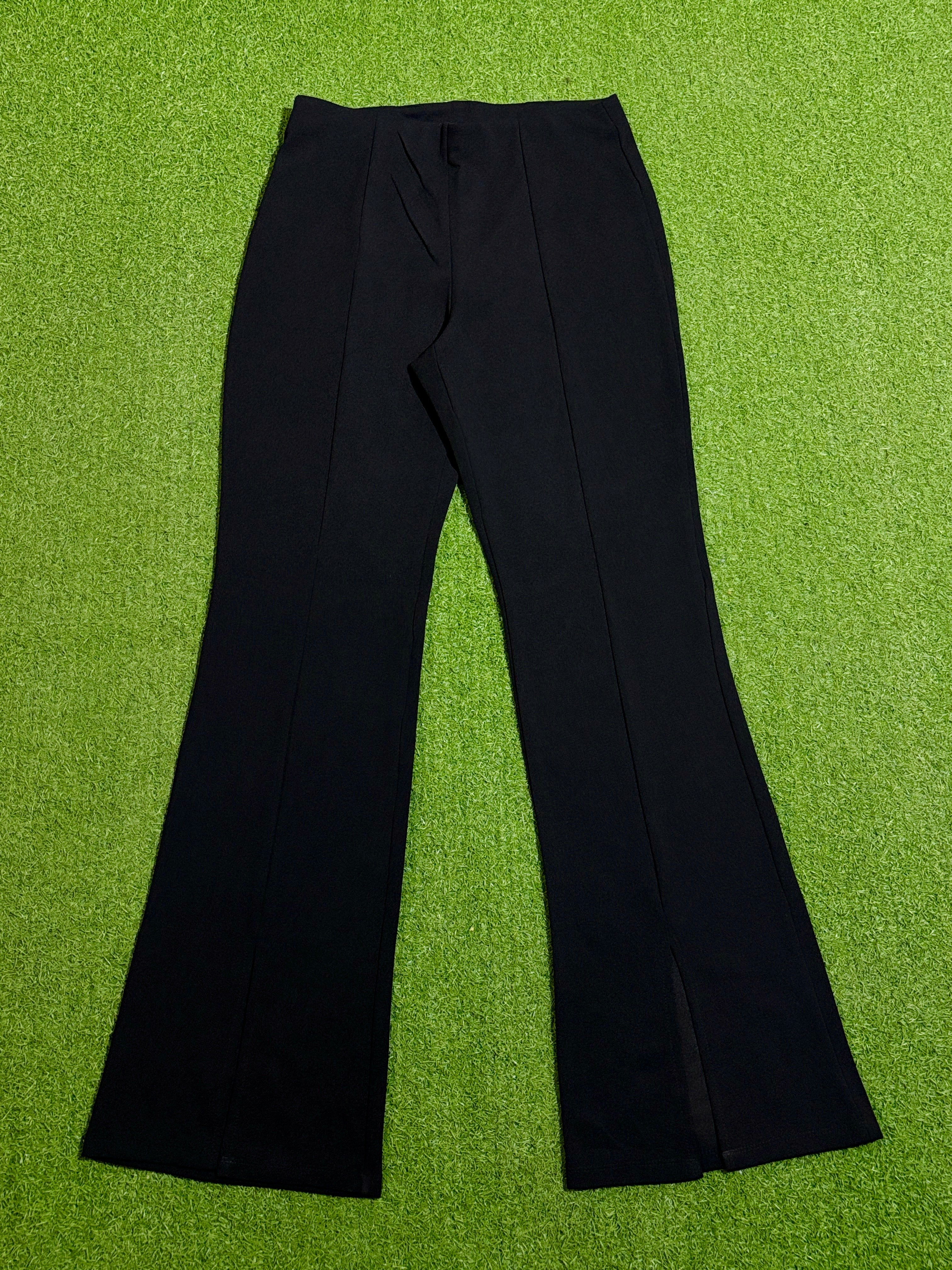 Black high-rise flared trousers with front seam detailing laid flat
