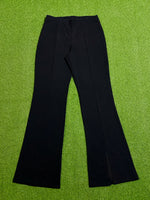 Black high-rise flared trousers with front seam detailing laid flat