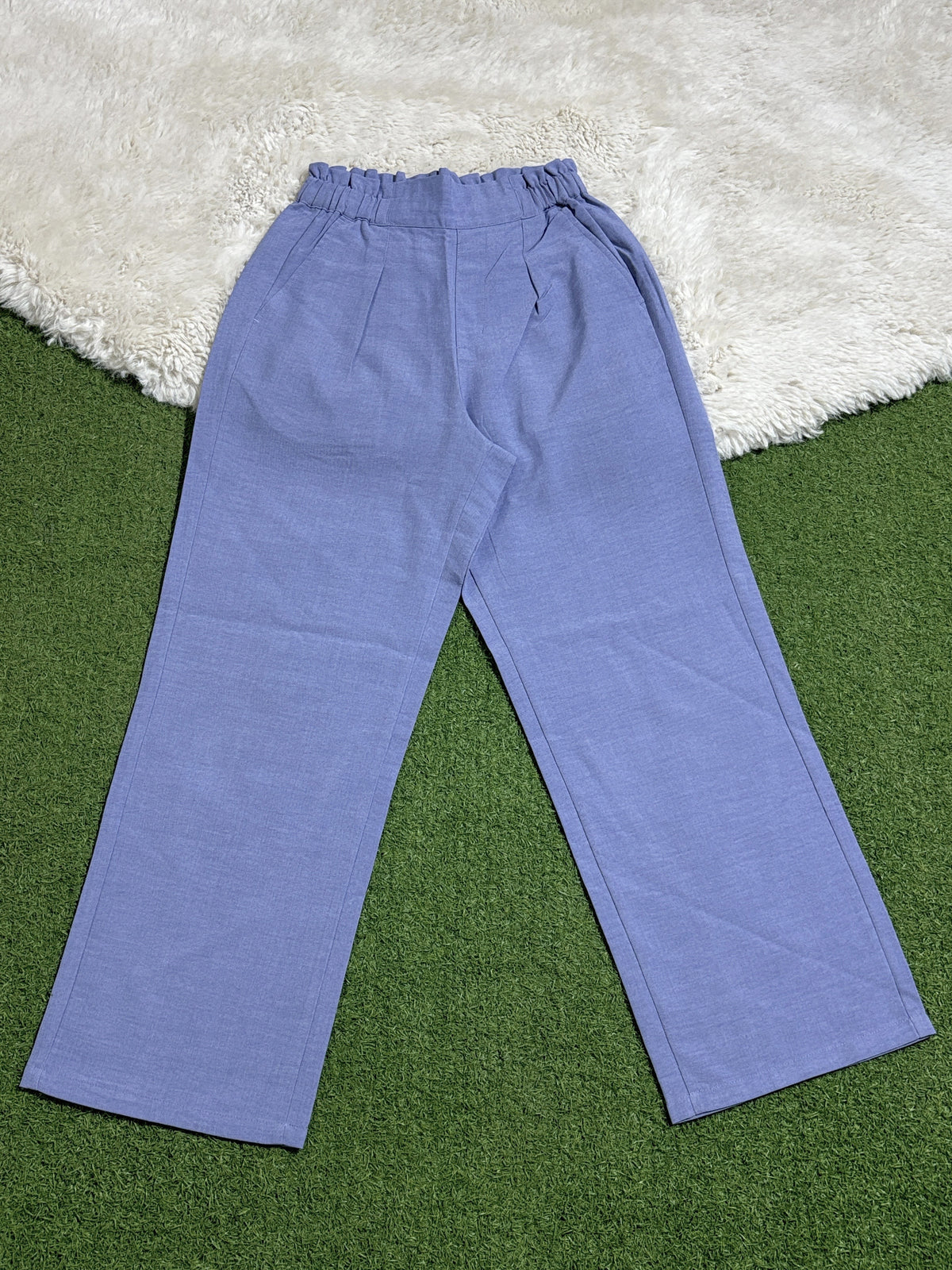Light blue high-rise straight-leg trousers laid flat