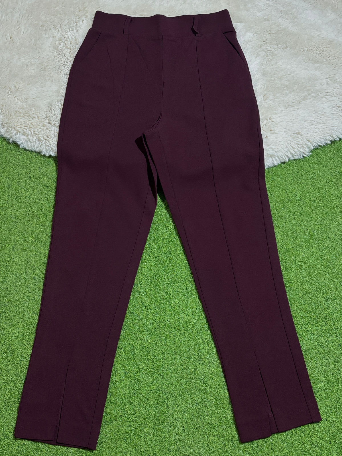 Burgundy high-rise straight-leg trousers laid flat