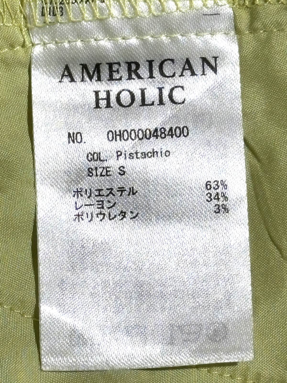 American Holic label showing pistachio color, size S and fabric composition