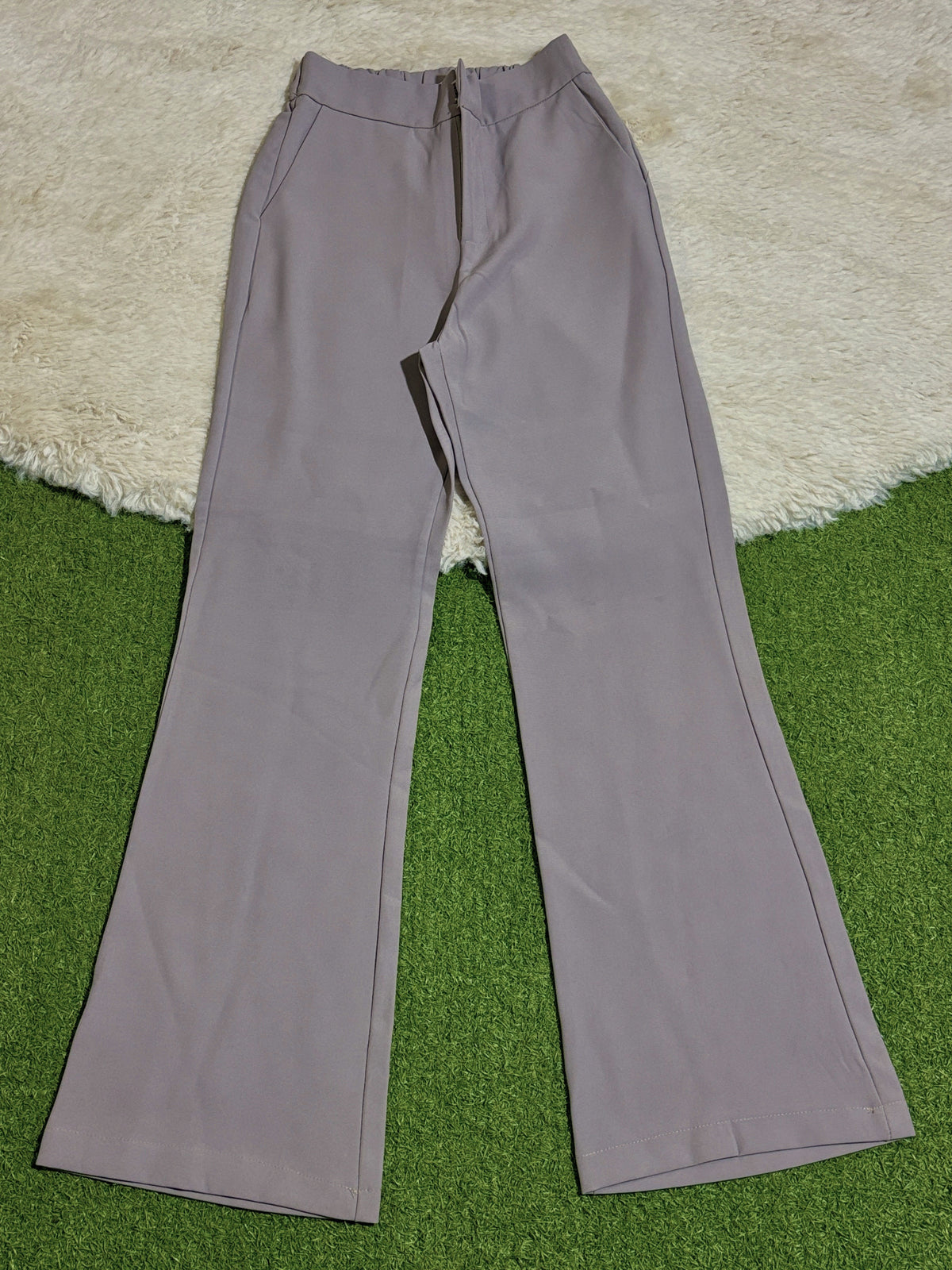High-rise straight-leg pants with side pockets laid flat