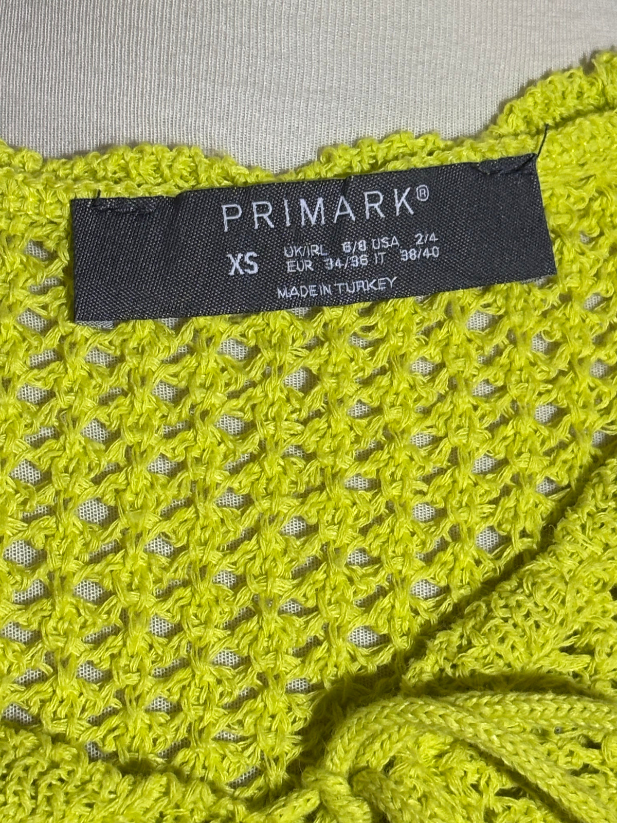 Primark XS label on lime green cardigan