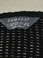 Primark size L label on black openwork crop top