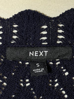 Next size S label on black vest