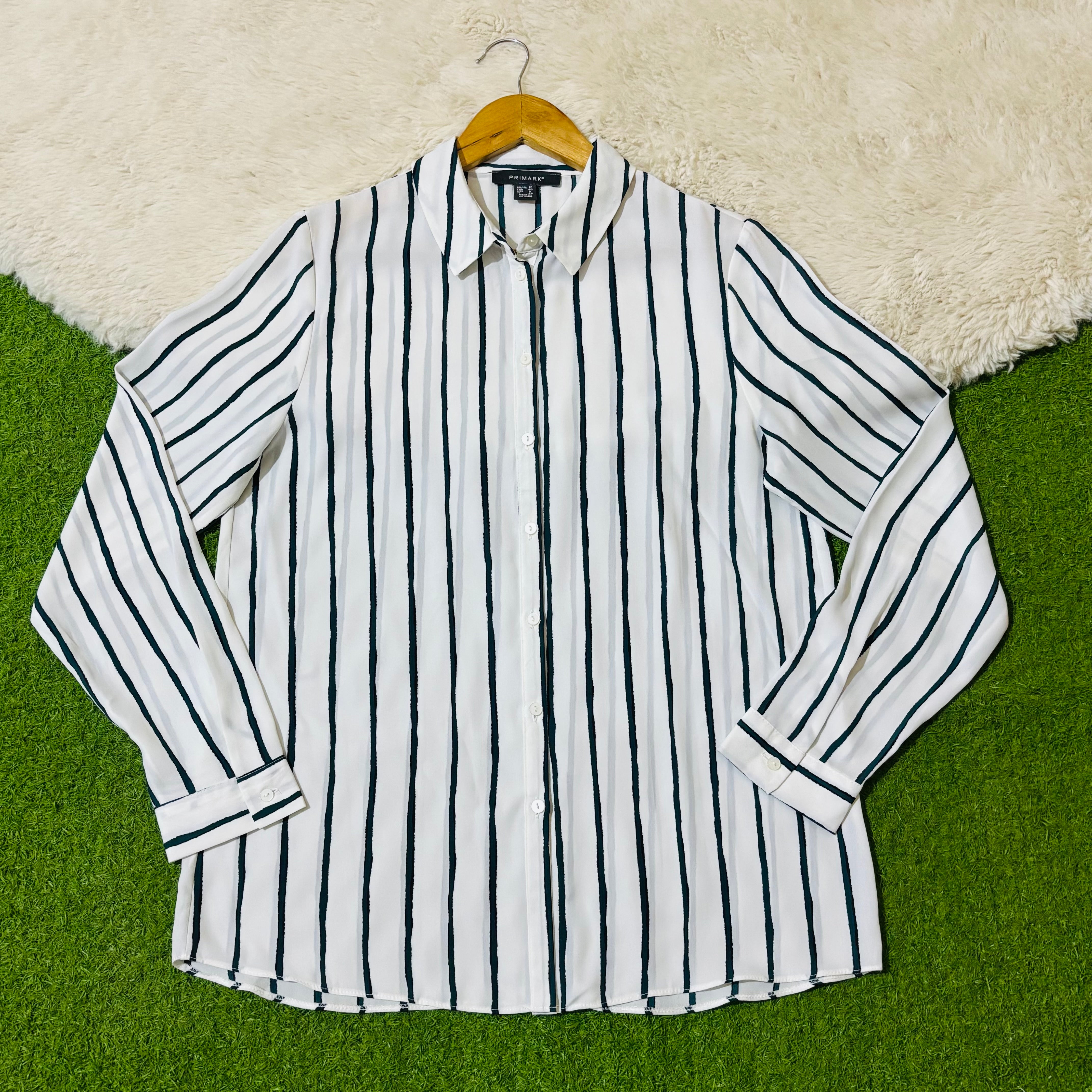 White and black vertical striped button-down shirt with long sleeves