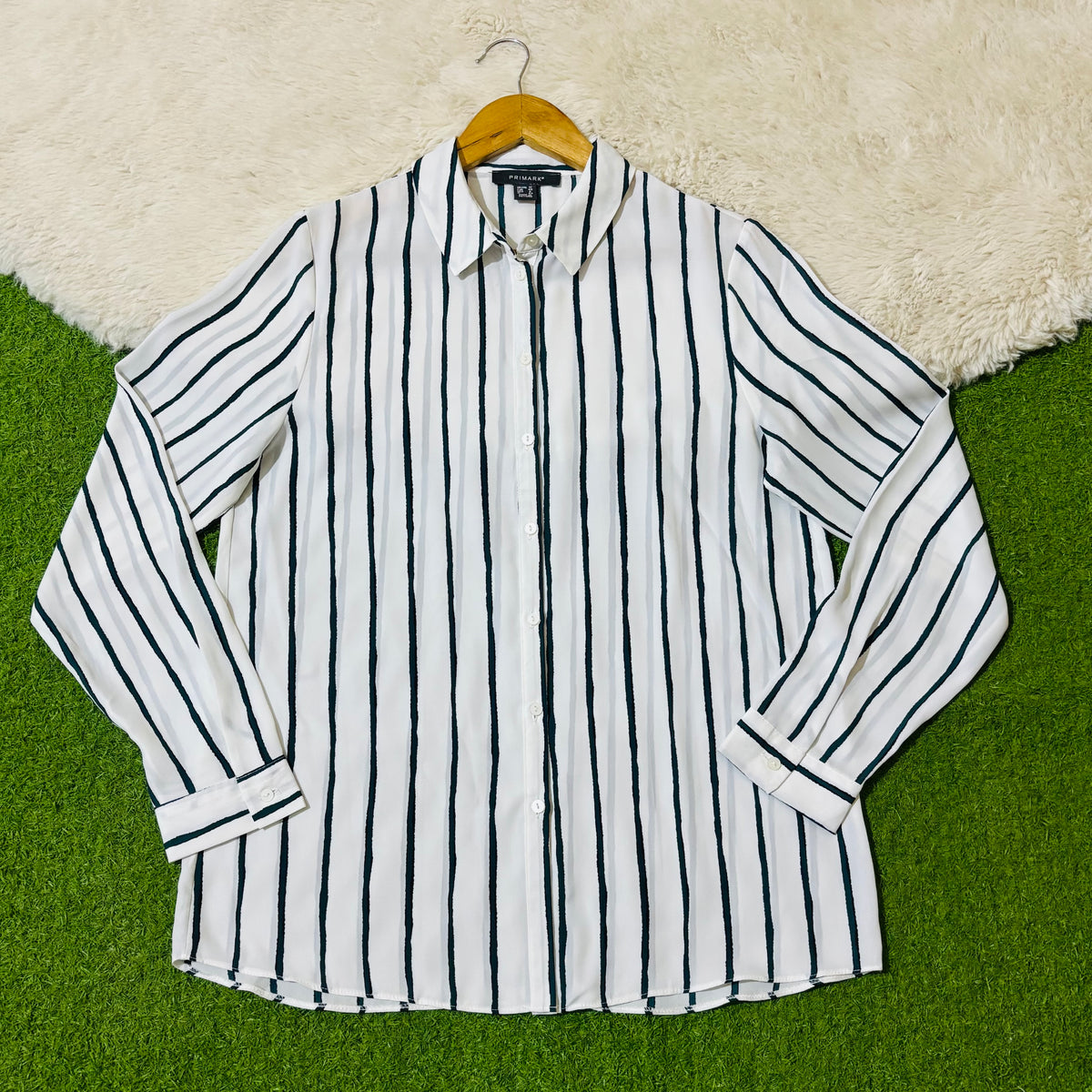 White and black vertical striped button-down shirt with long sleeves
