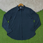 Navy blue concealed button-front shirt with pointed collar and long cuffed sleeves