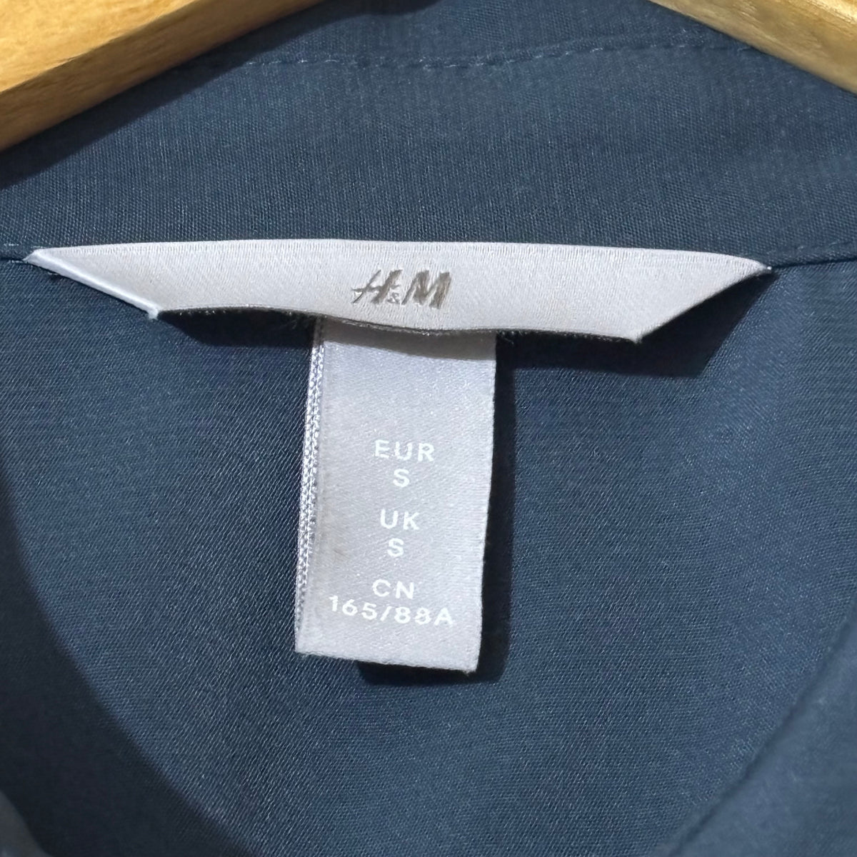 H&M shirt label showing size S