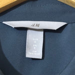 H&M shirt label showing size S