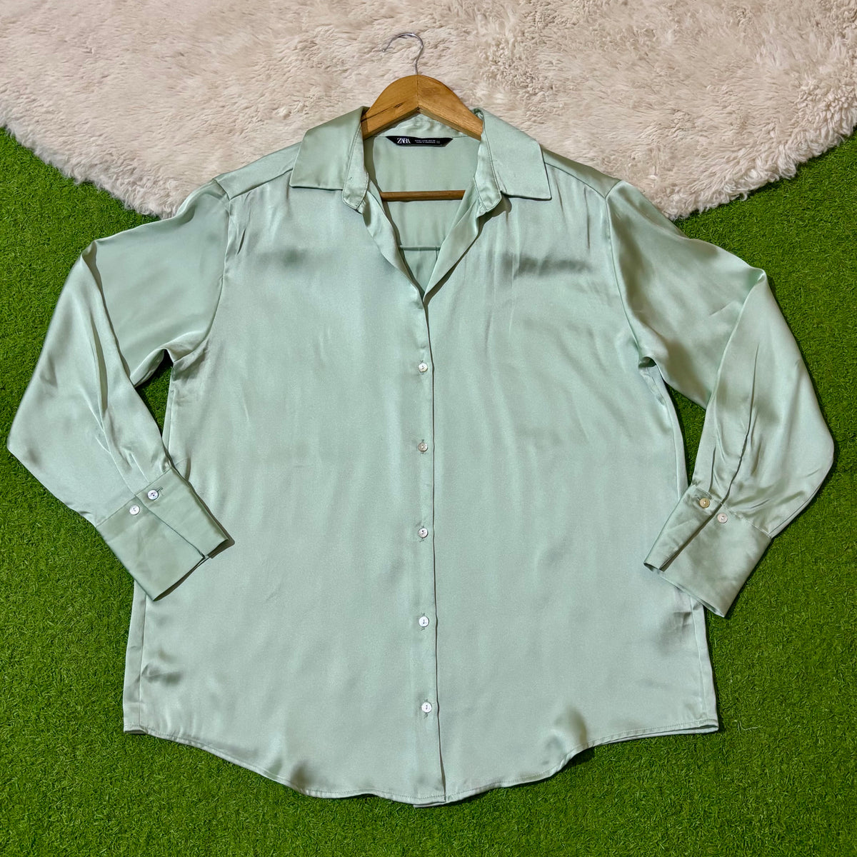 Mint green classic button-down shirt with open pointed collar and long cuffed sleeves