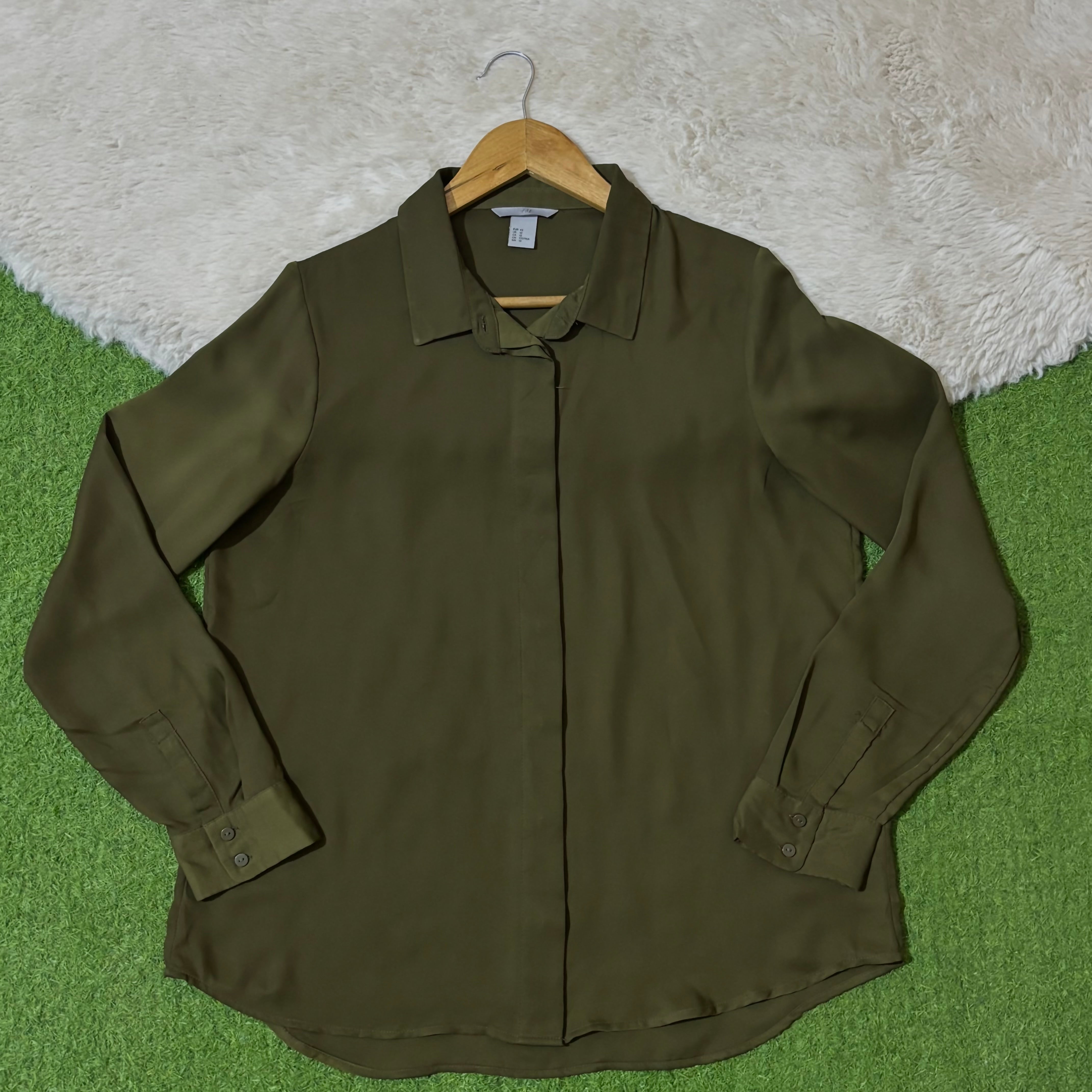 Olive green concealed button-front shirt with long cuffed sleeves