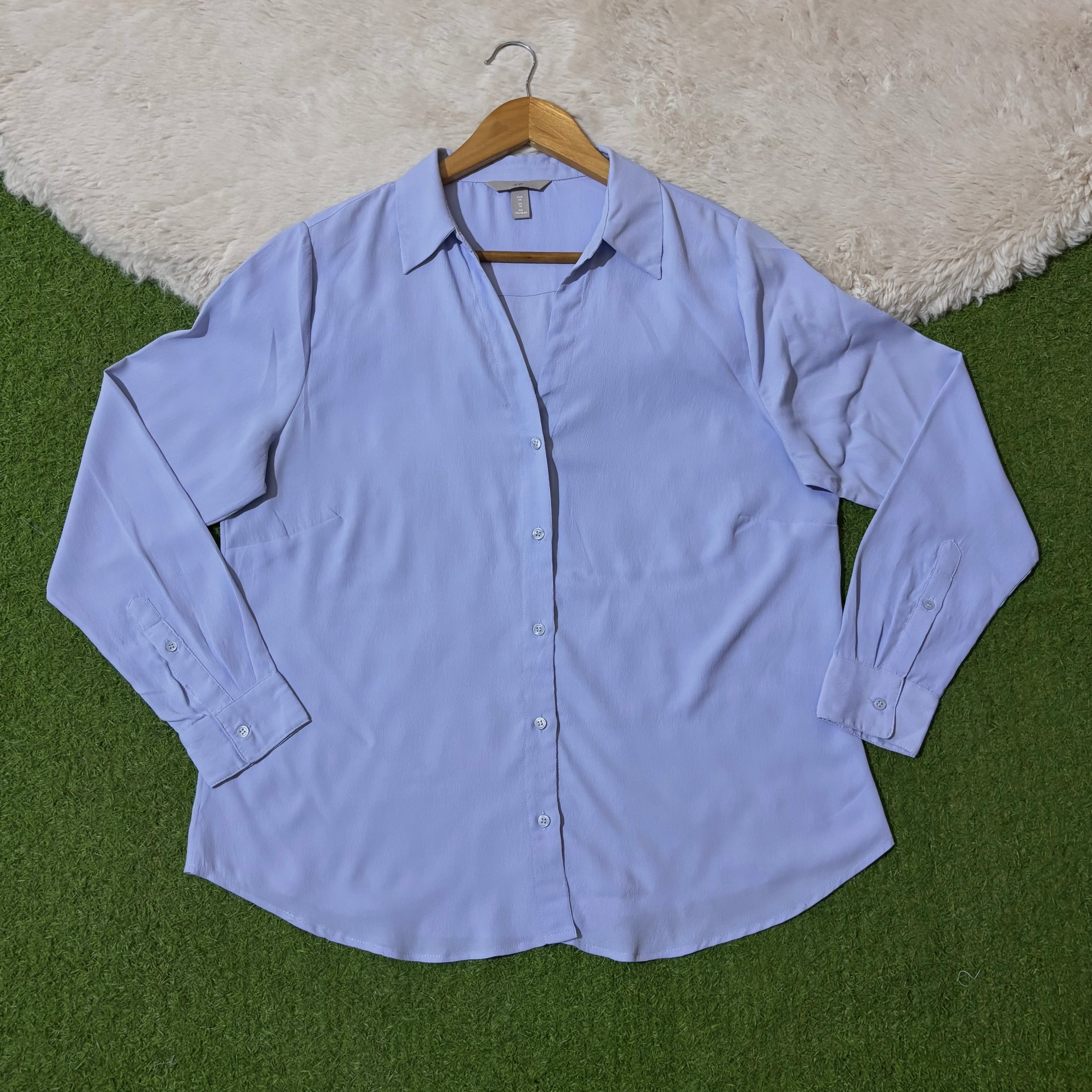 Light blue classic button-down shirt with pointed collar and long cuffed sleeves