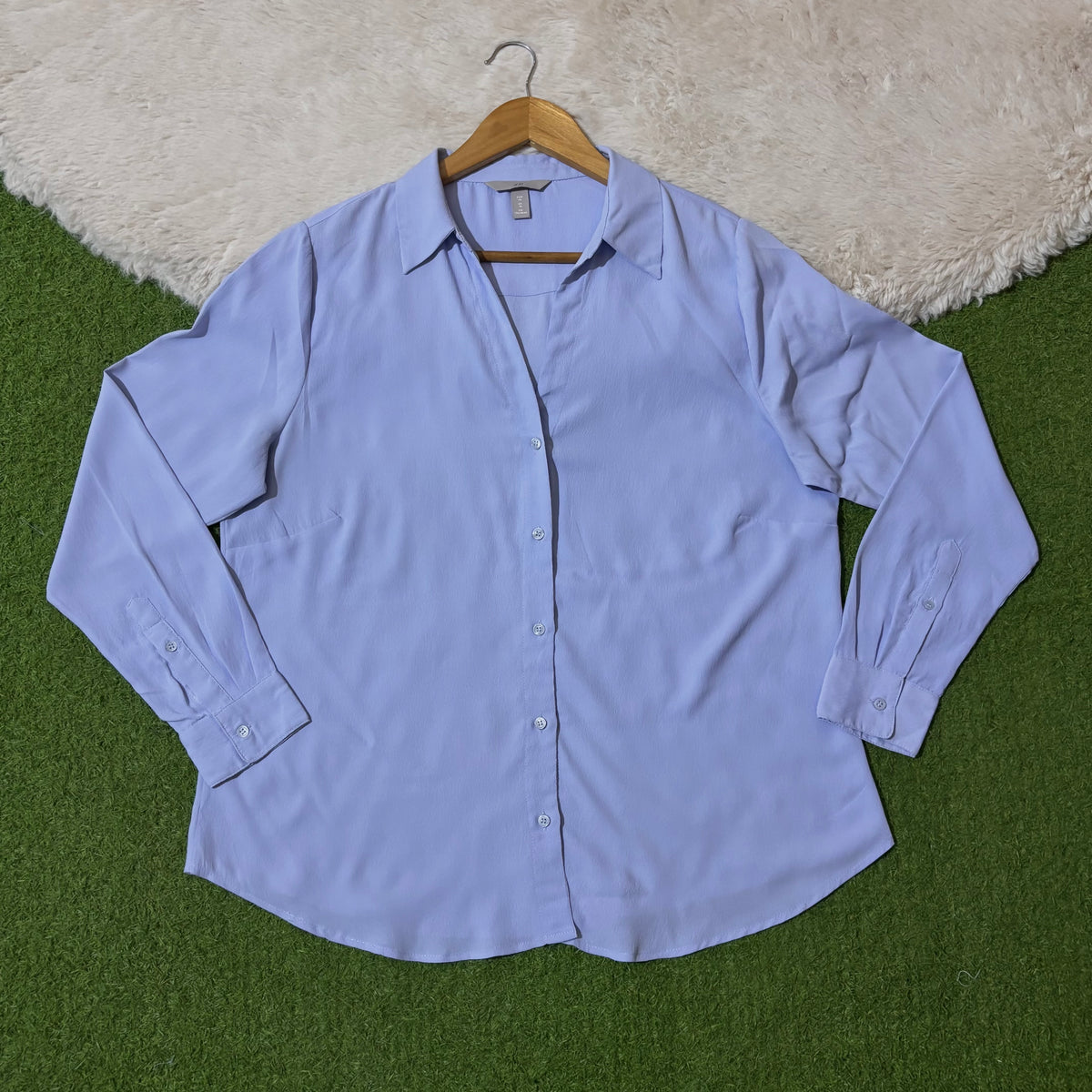 Light blue classic button-down shirt with pointed collar and long cuffed sleeves