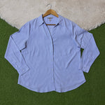 Light blue classic button-down shirt with pointed collar and long cuffed sleeves