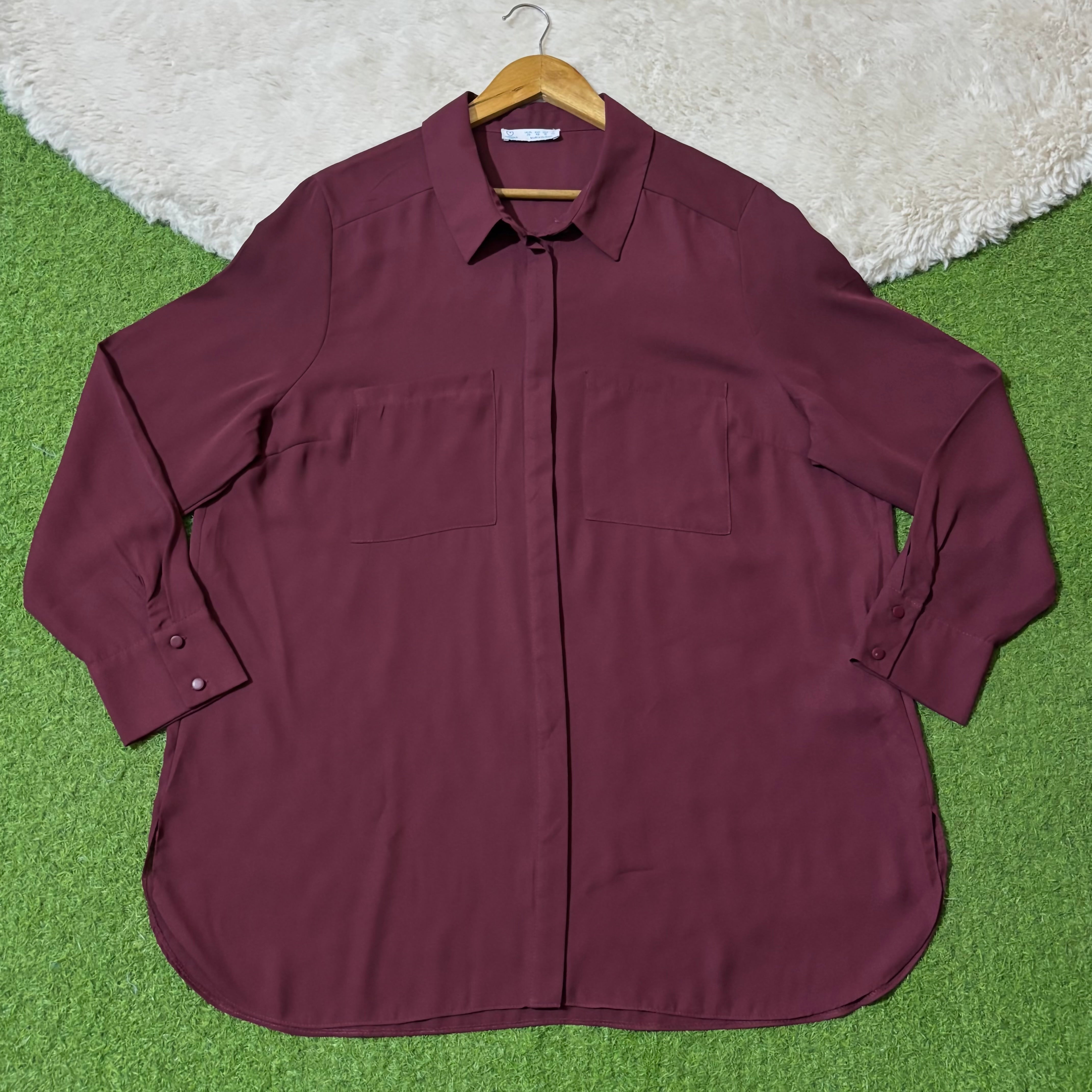 Burgundy longline collared shirt with twin chest pockets and concealed buttons