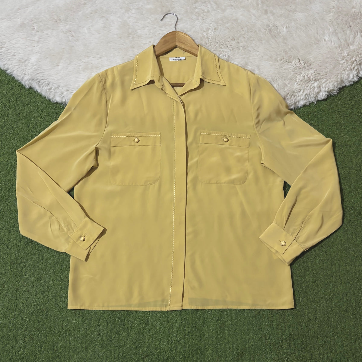 Yellow collared shirt with twin buttoned chest pockets and concealed button front
