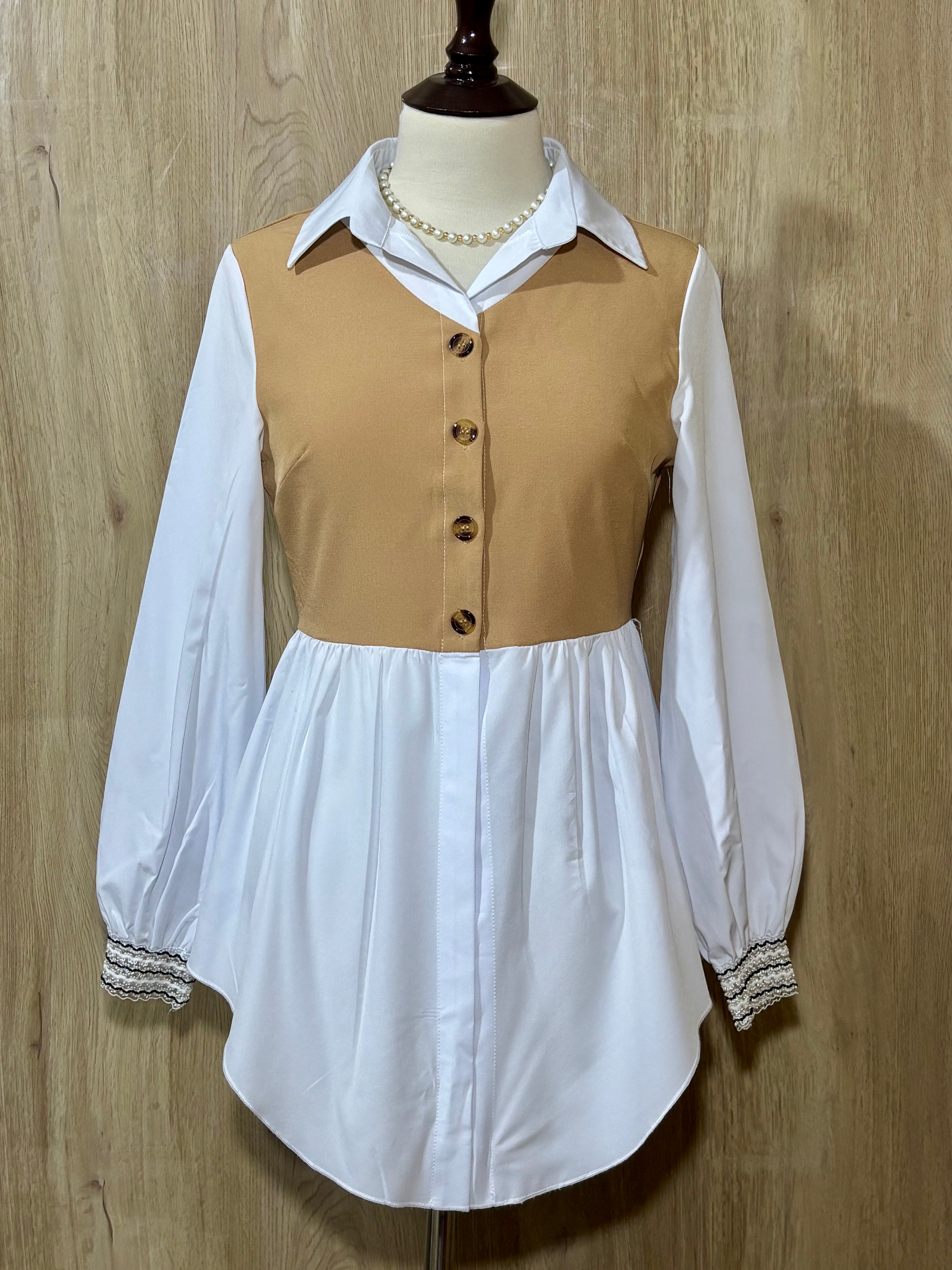 Front of beige and white layered-look collared peplum shirt with smocked cuffs