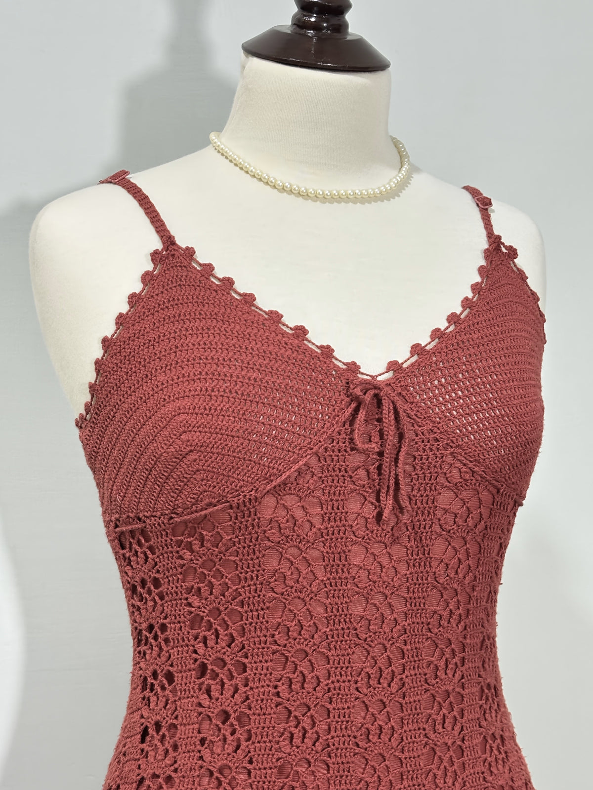 Scalloped V-neckline and tie-front detail on dusty rose dress