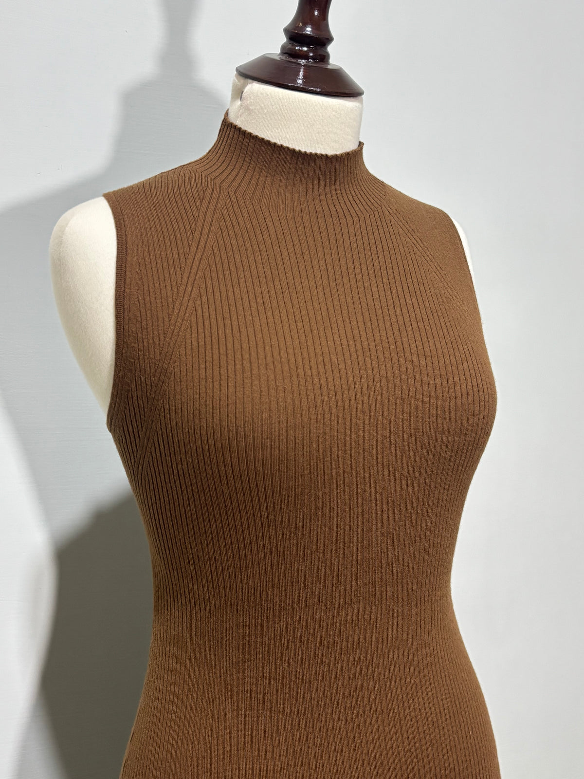 Angled shoulder detailing on brown ribbed dress