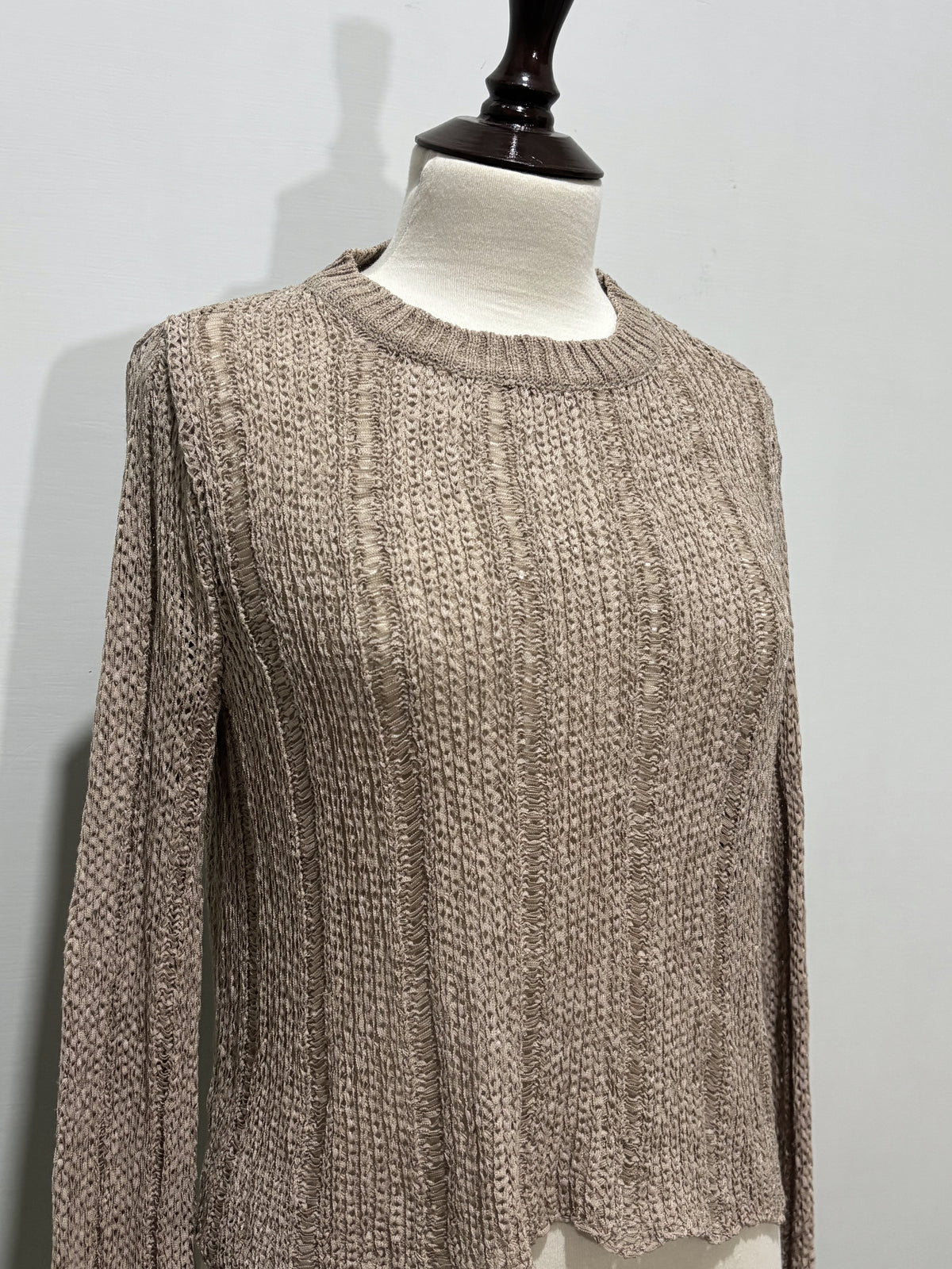 Close-up of taupe crop top textured detail and round neckline