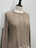 Close-up of taupe crop top textured detail and round neckline