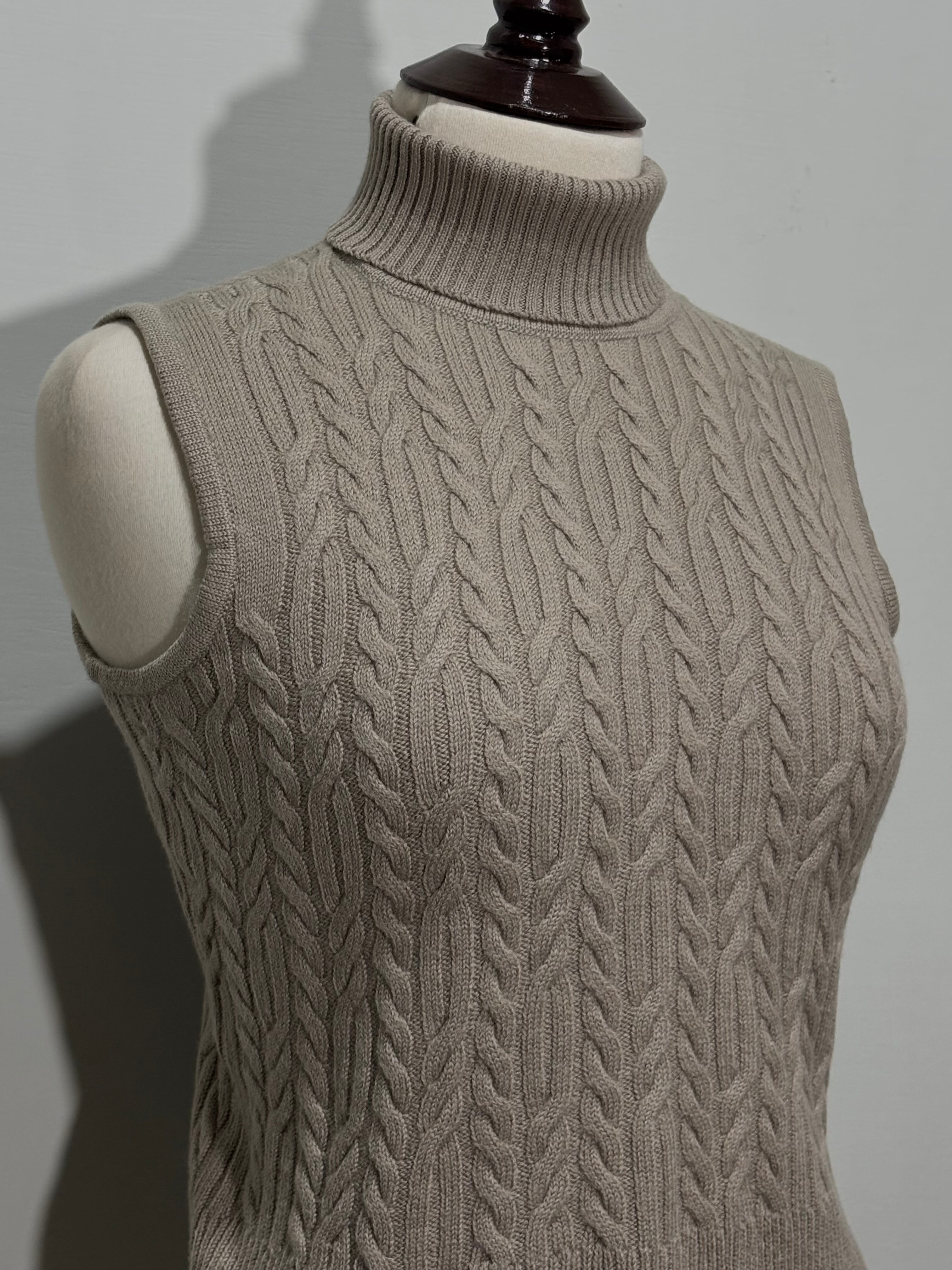 Beige sleeveless turtleneck top cable detailing