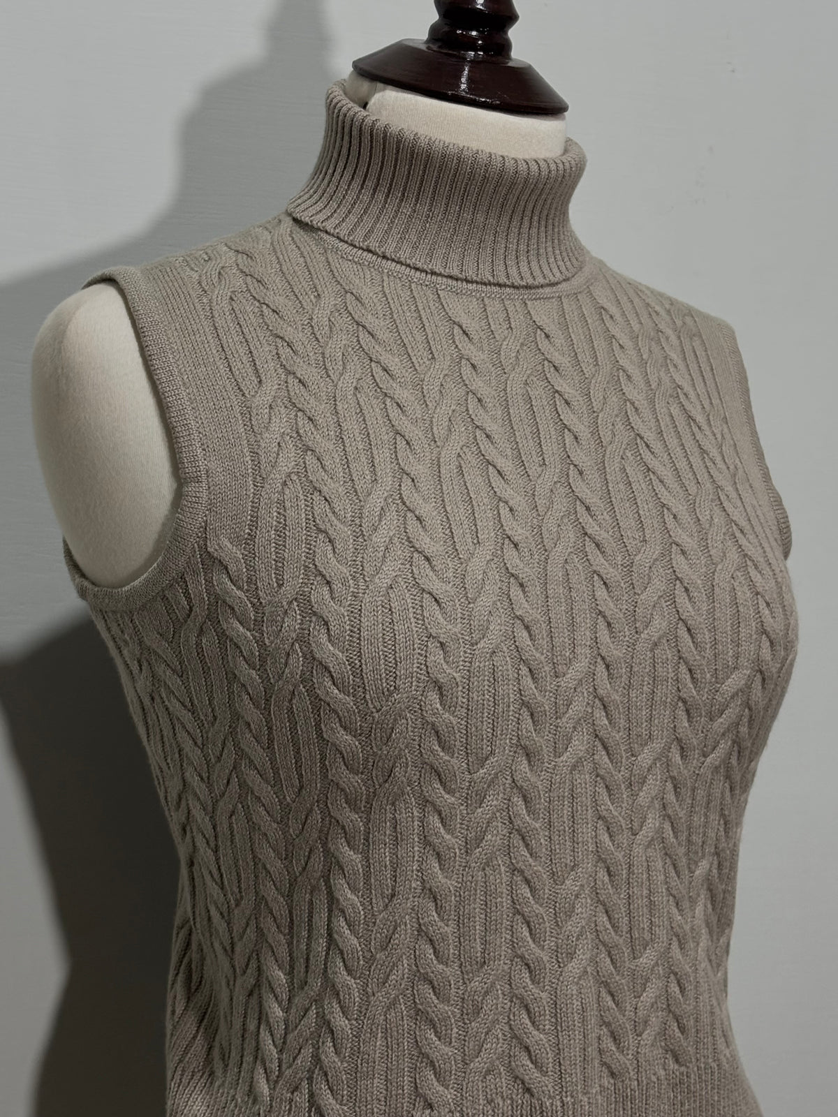 Beige sleeveless turtleneck top cable detailing