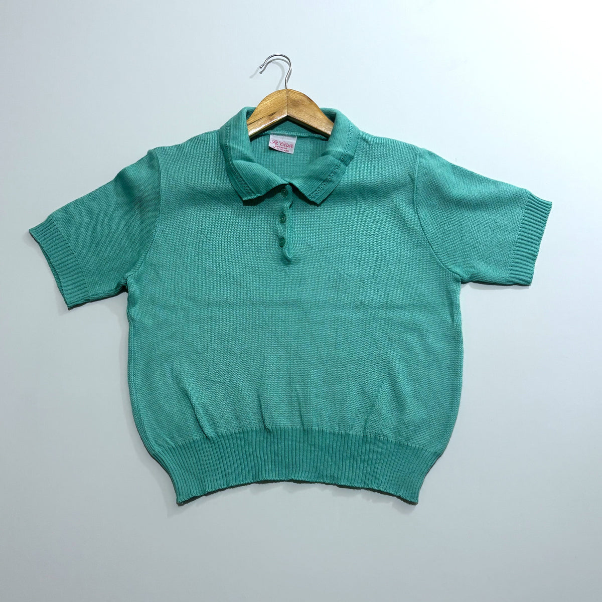 Teal green short-sleeve polo top with ribbed cuffs and hem
