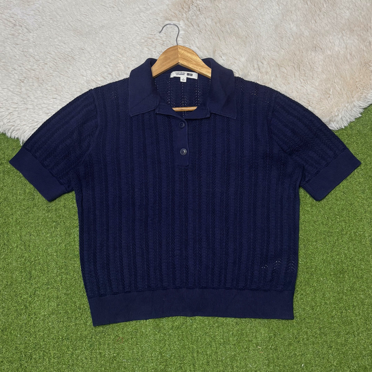 Navy blue short-sleeve pointelle polo top with button placket