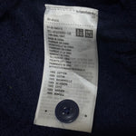 Uniqlo care label confirming 100% cotton