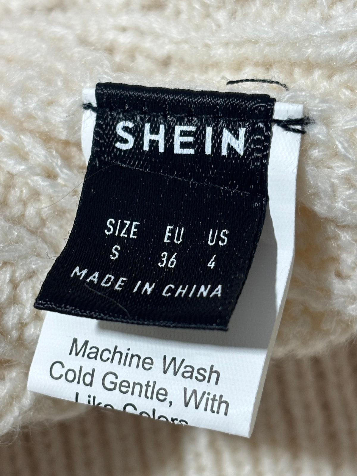SHEIN skirt label showing size S EU 36 US 4