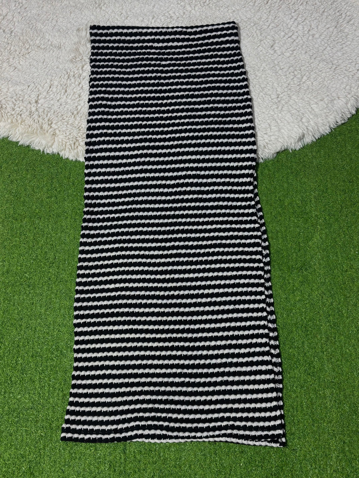 Black and white striped winter midi skirt laid flat