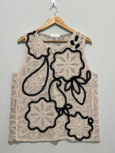 Beige openwork sleeveless top with black floral outlines