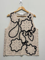 Beige openwork sleeveless top with black floral outlines