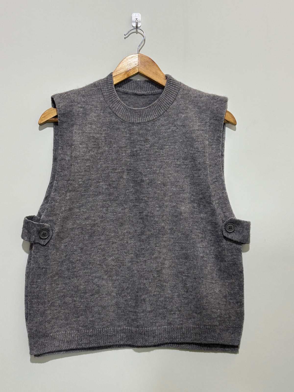 Grey sleeveless round-neck winter top with side-button tabs