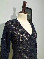 Side detail of black floral openwork long-sleeve top