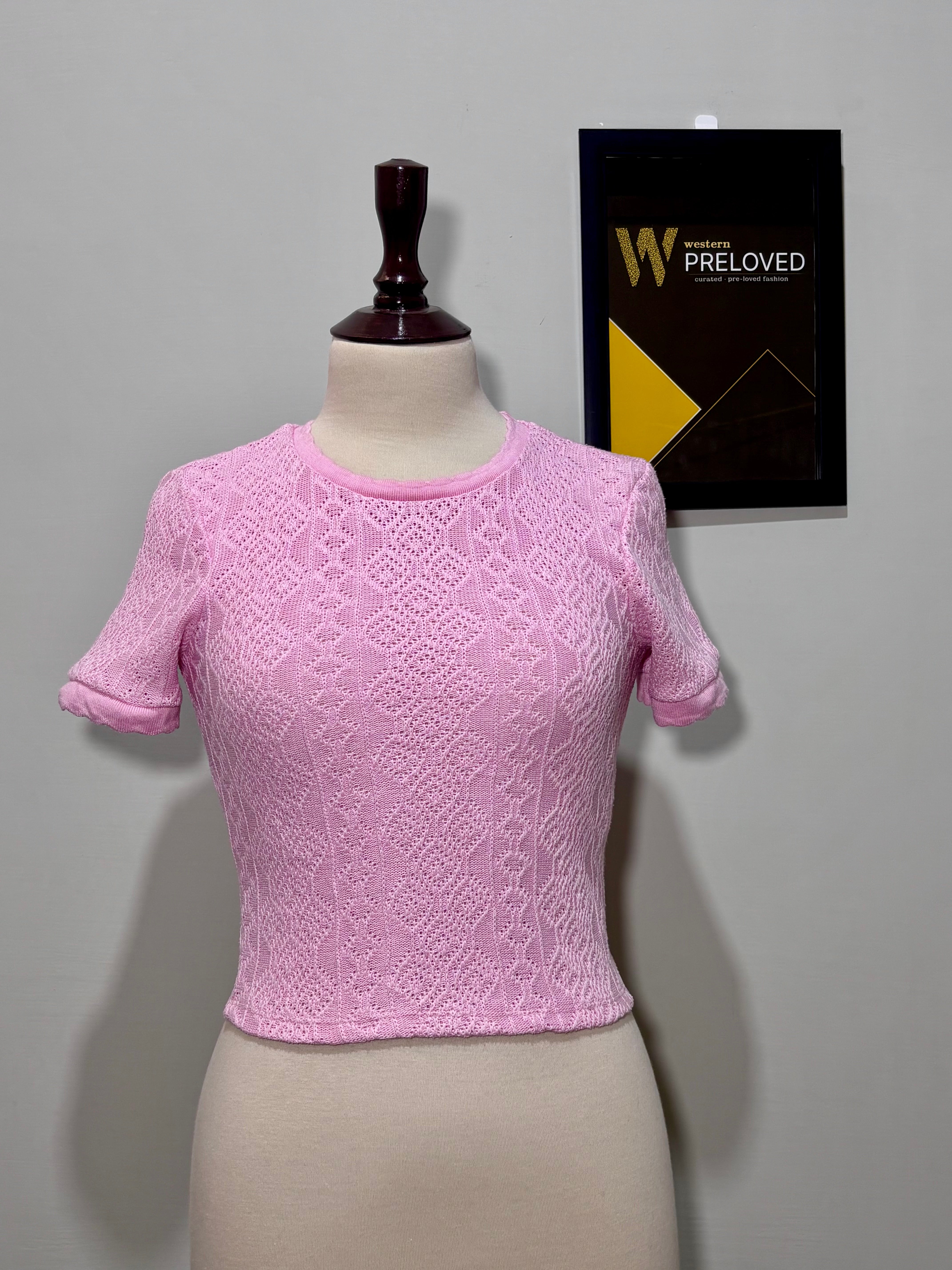 Pink round-neck short-sleeve top with intricate openwork pattern
