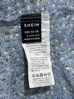 SHEIN label showing L EU 40/42 US 8/10 and 100% Polyester