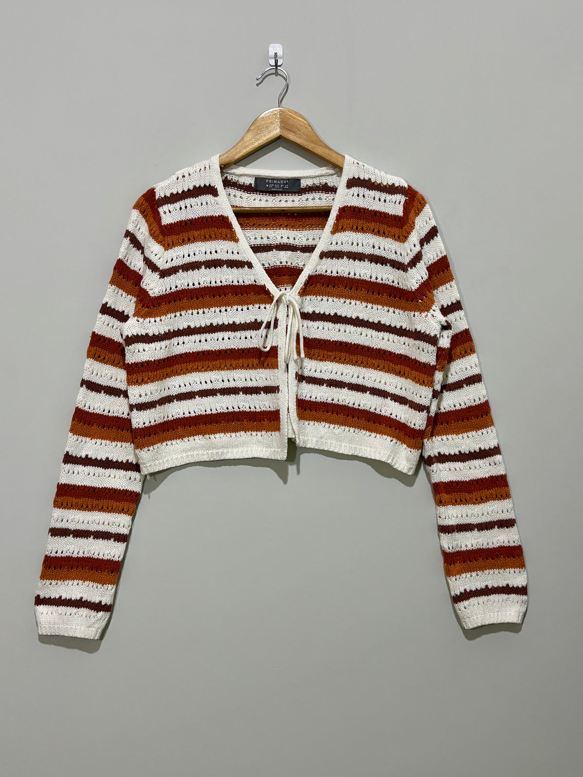 Striped openwork long-sleeve tie-front top on hanger