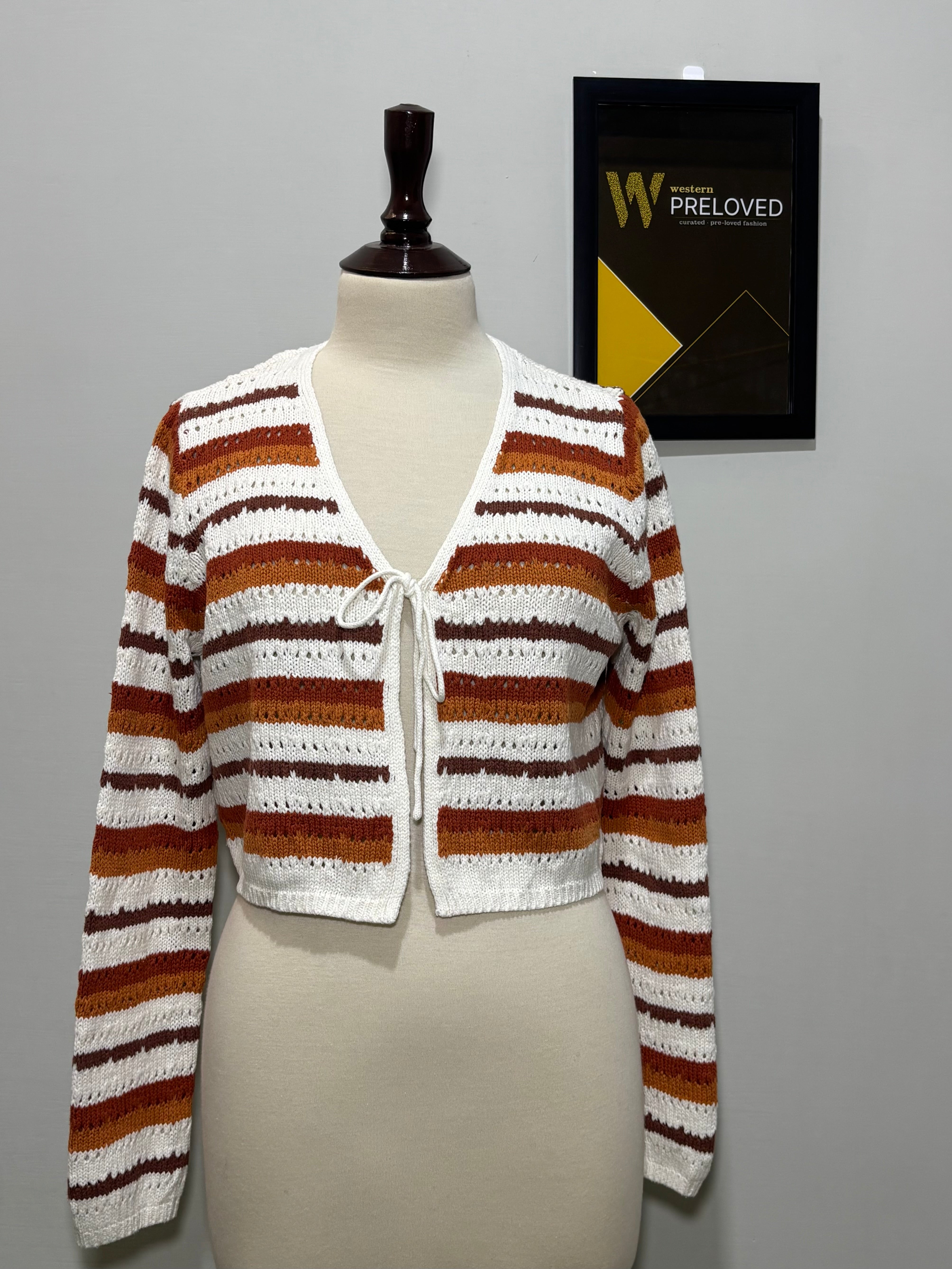 White rust and brown striped V-neck tie-front top on mannequin