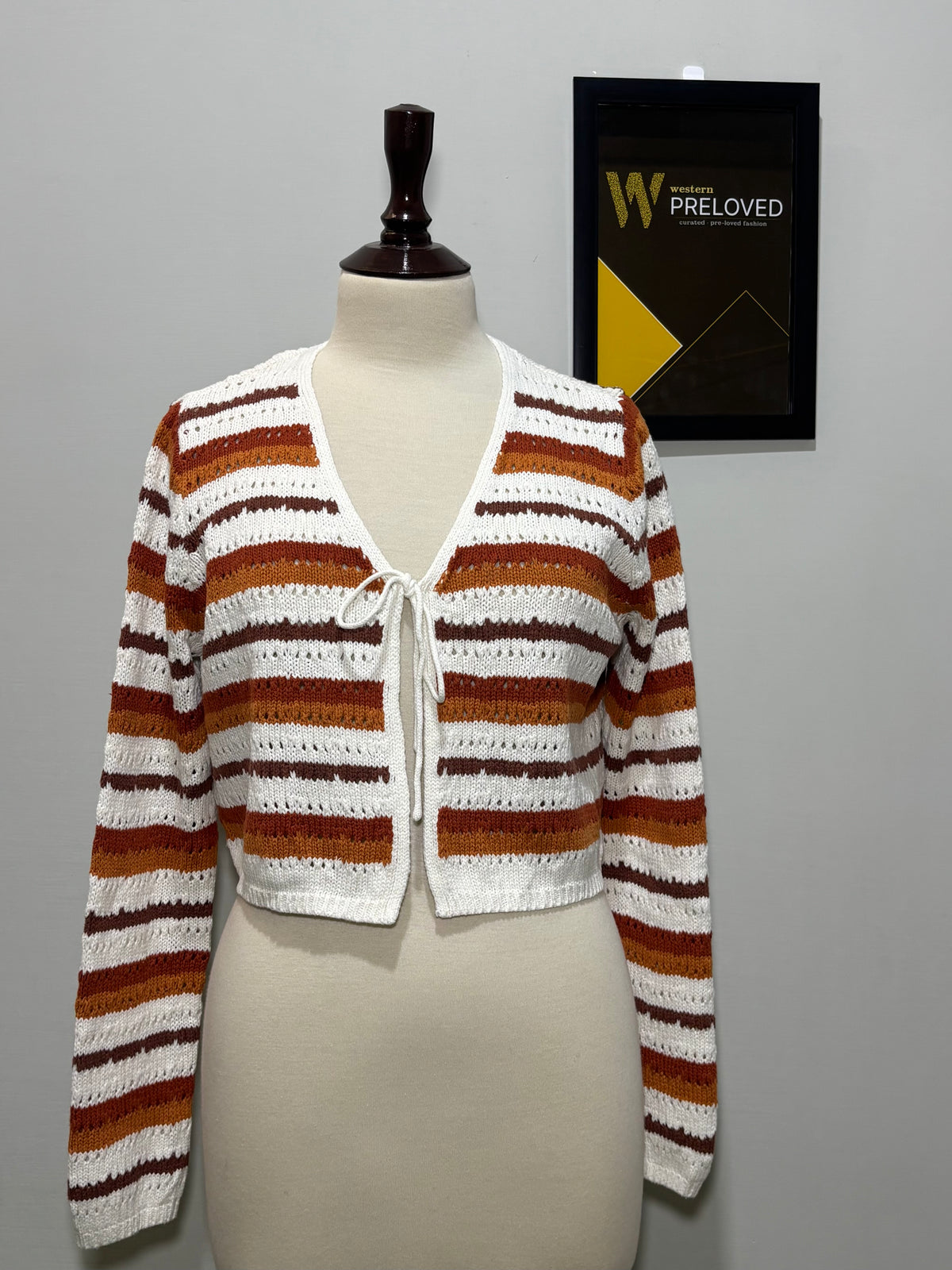 White rust and brown striped V-neck tie-front top on mannequin